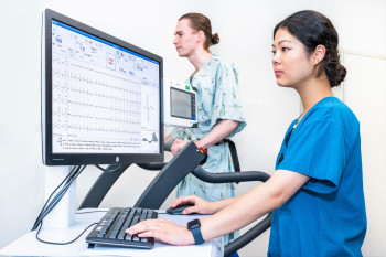 a health professional monitoring a patients heart rate